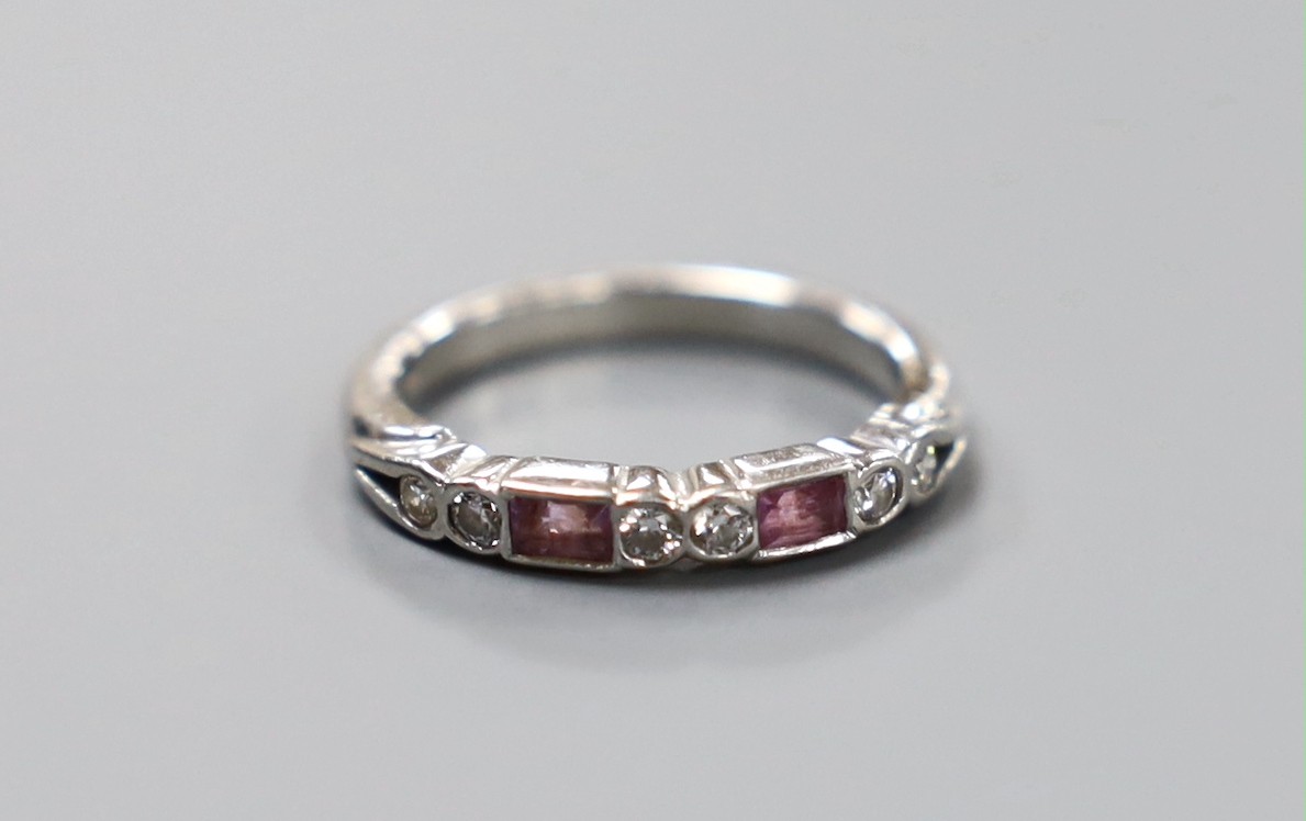 A modern platinum, two stone pink sapphire and six stone diamond set half hoop ring, size H, gross weight 3.9 grams.
